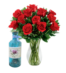 12 red roses in vase with bottle message